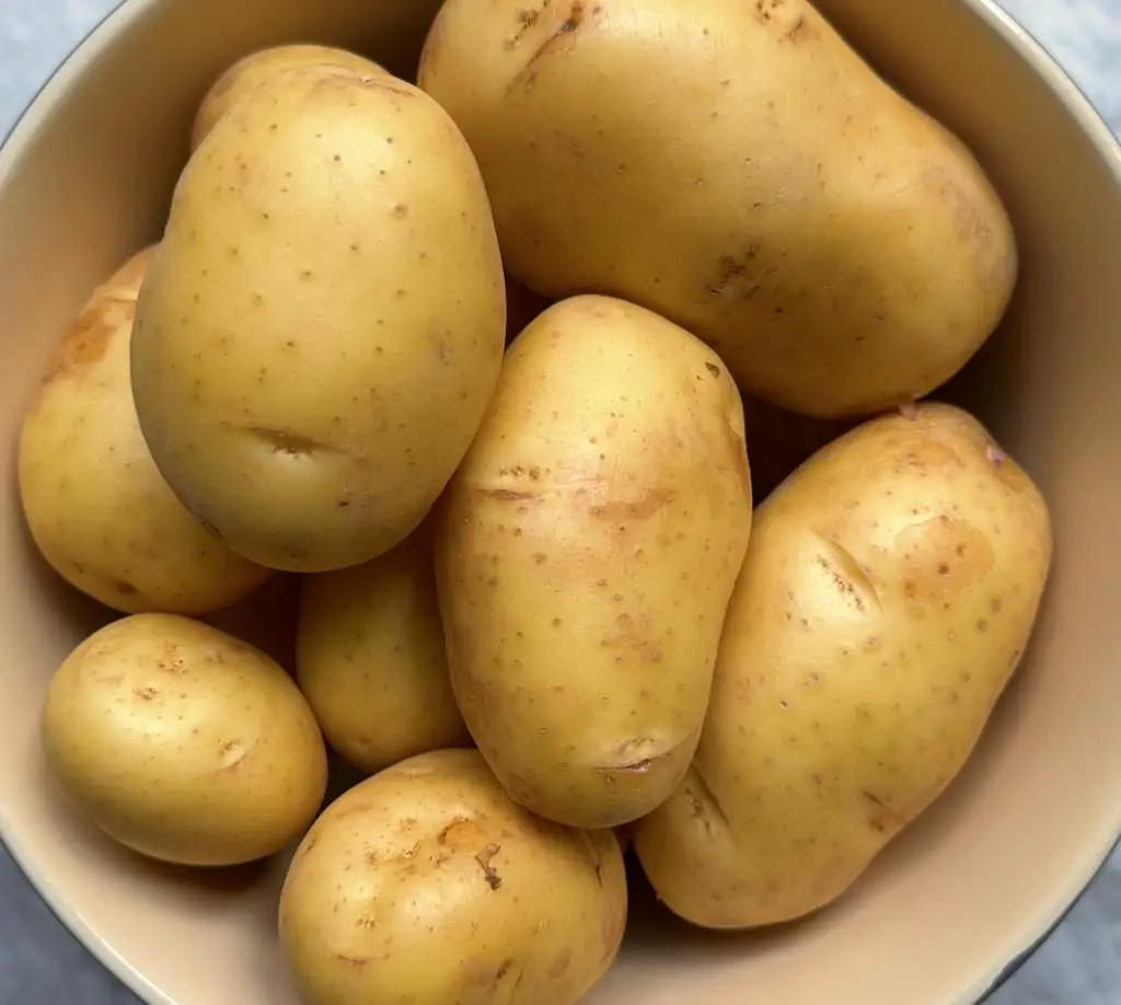 Bowl of uncut, unpeeled yukon gold potatoes