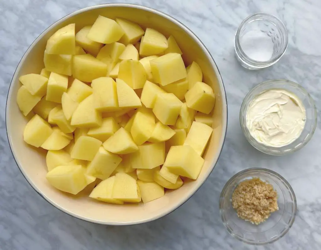 Ingredients for vegan mashed potatoes in individual bowls