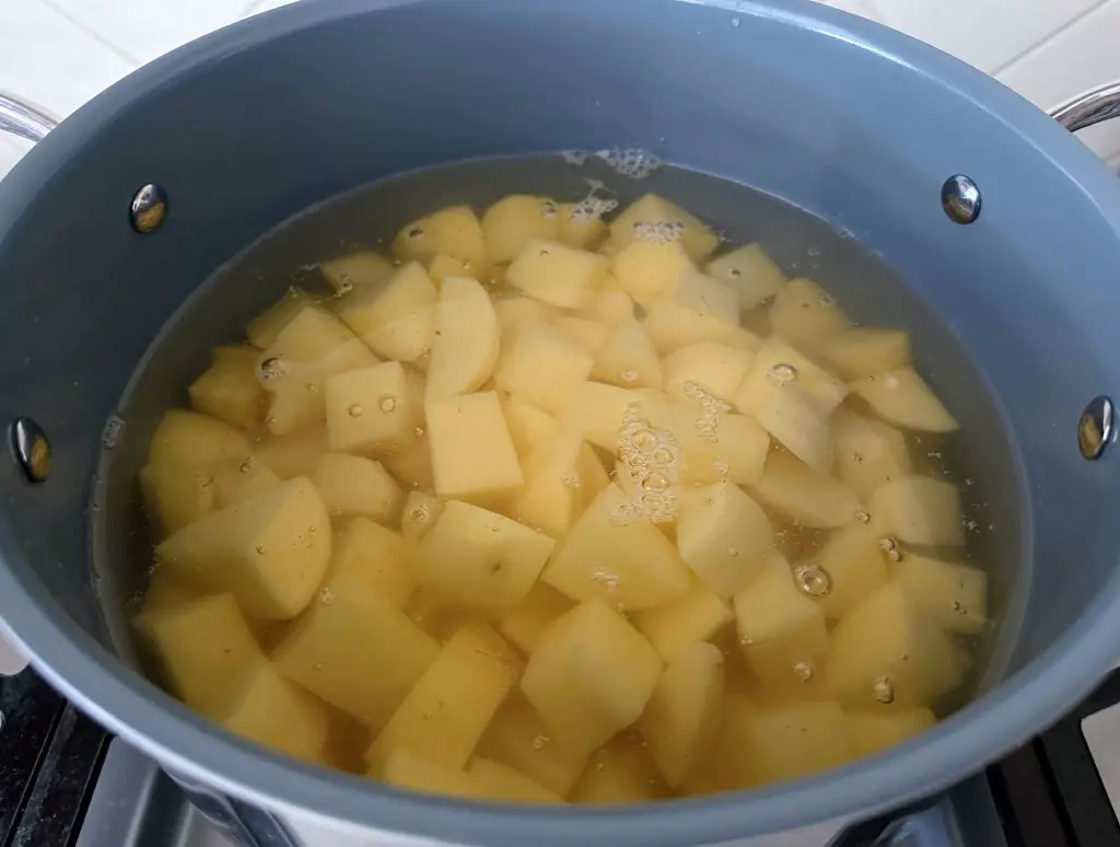 Chopped potatoes in a pot of boiling water