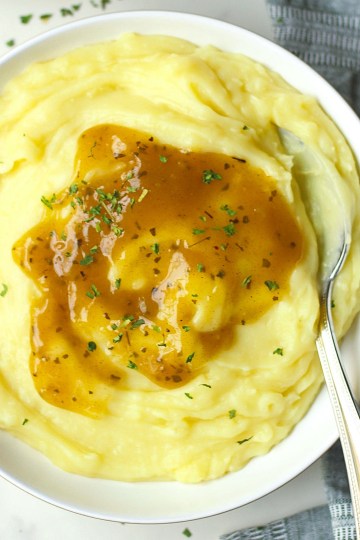 bowl of mashed potatoes with vegan gravy on top
