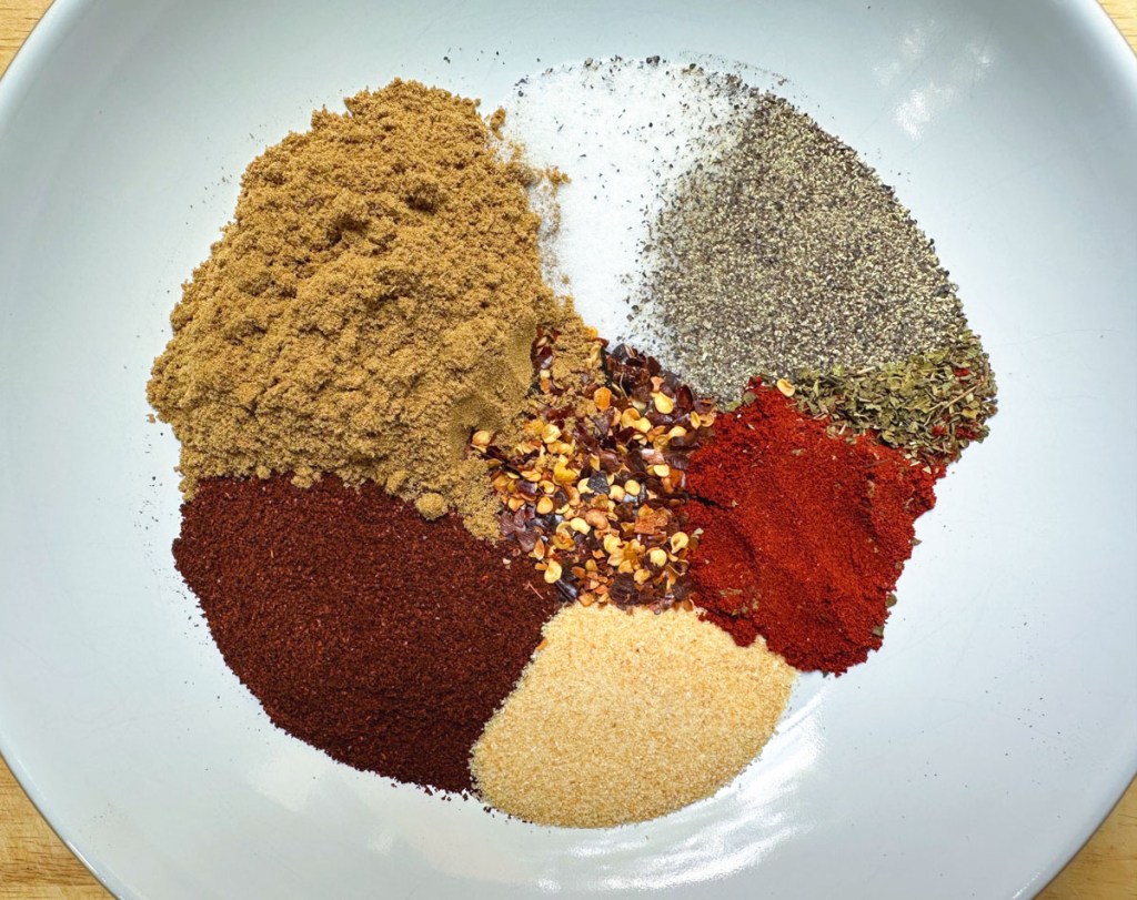 ingredients for homemade taco seasoning in a bowl before being mixed