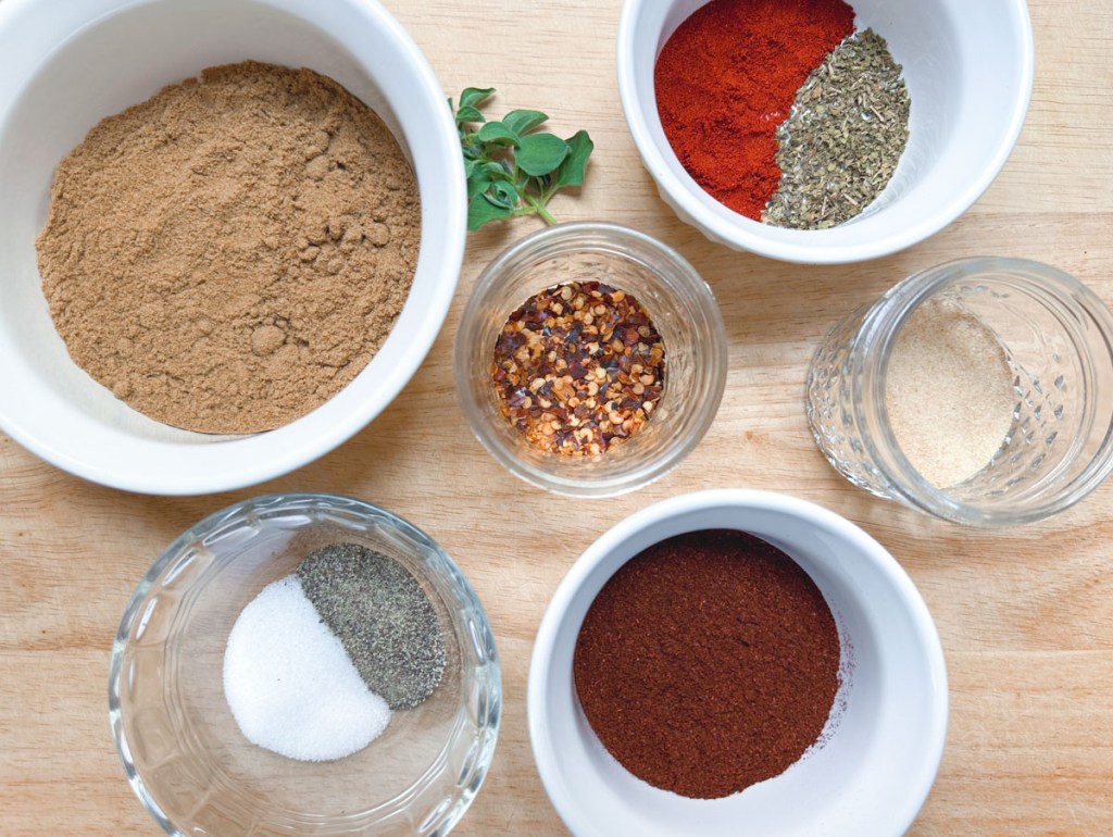 ingredients to vegan taco seasoning in individual bowls