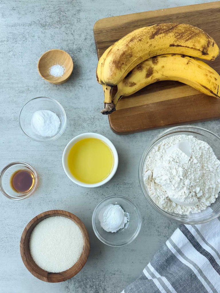 ingredients for vegan banana bread on a grey background