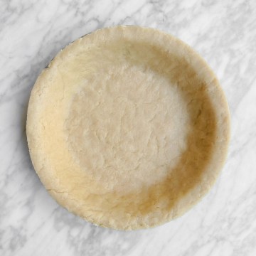Completed easy vegan pie crust in a pie tin, uncooked.