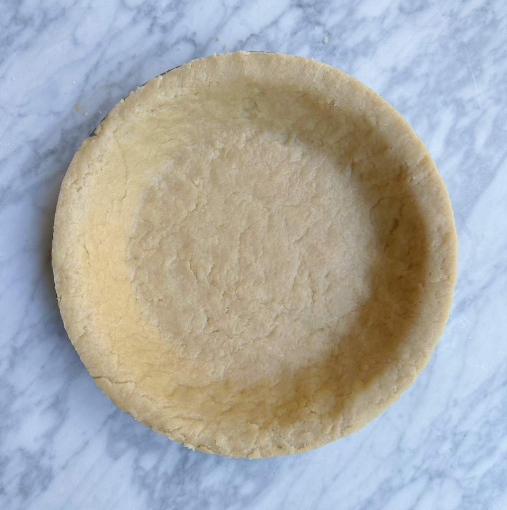 Completed easy vegan pie crust in a pie tin, uncooked.