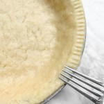 easy vegan Pie crust in tin with fork making marks around edge