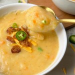 vegan baked potato soup with spoon
