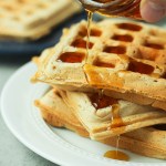 vegan belgian waffles with syrup pouring overtop