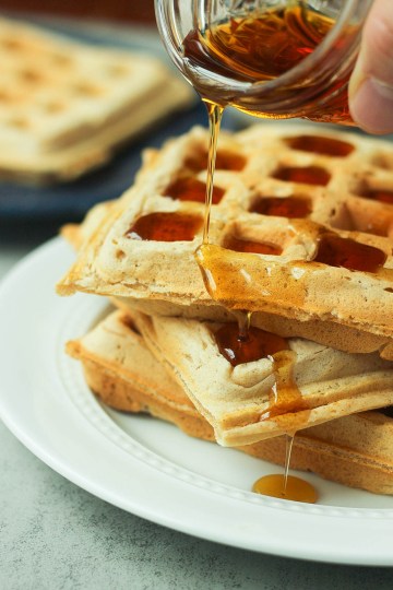vegan belgian waffles with syrup pouring overtop