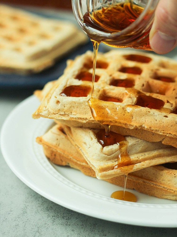 vegan belgian waffles with syrup pouring overtop