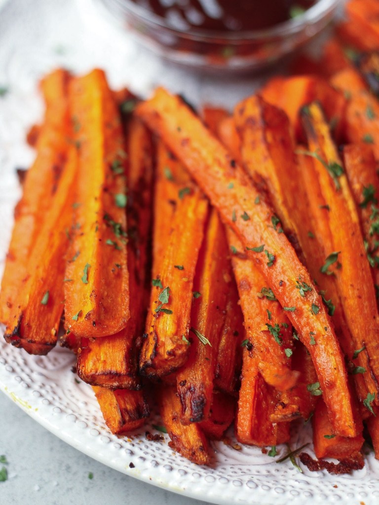 close up carrot fries on white plate