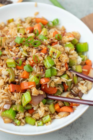 finished vegan fried rice in a white bowl with chopsticks