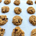 FInished vegan oatmeal raisin cookies on a cookie sheet