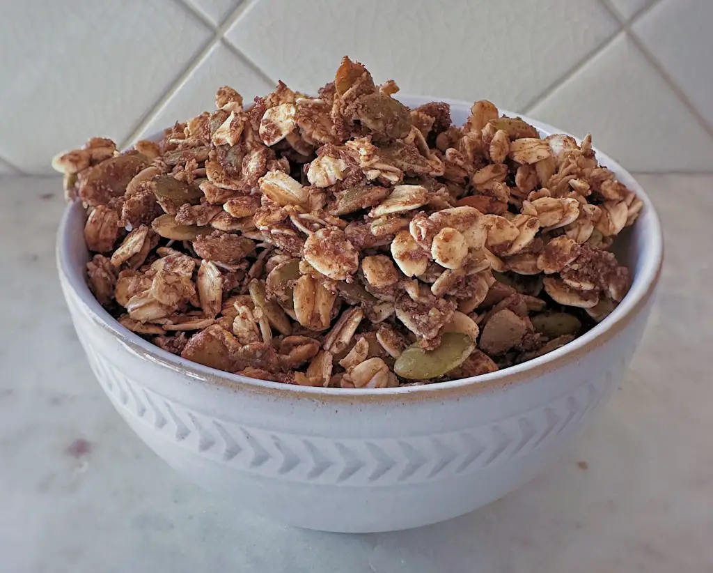 Bowl of nut-free granola on a white background