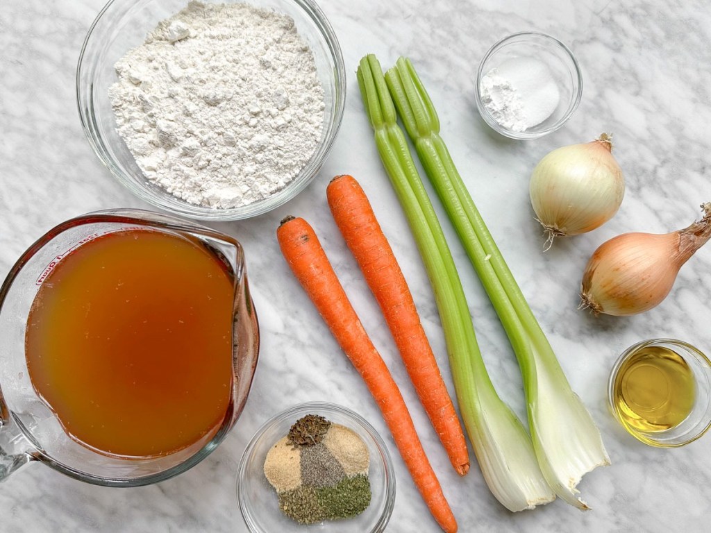 All ingredients for vegan dumpling soup on a marble background