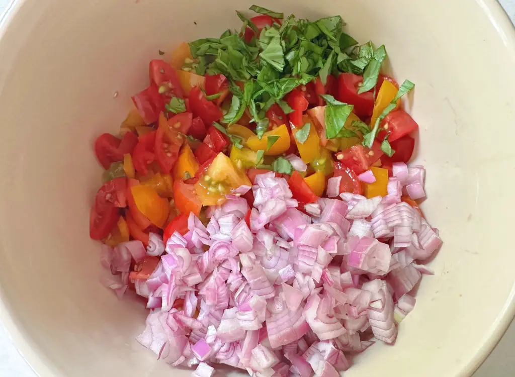 All ingredients for bruschetta dip in  a bowl