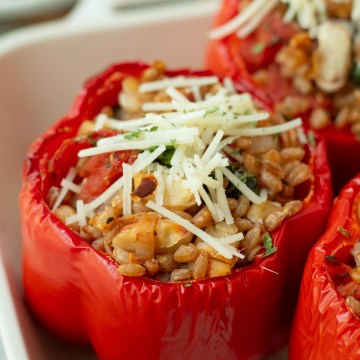 finished vegan italian stuffed peppers topped with vegan cheese