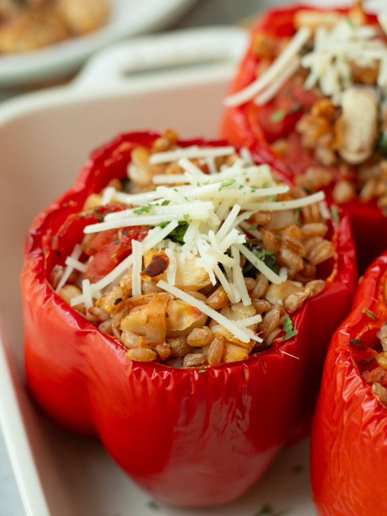 finished vegan italian stuffed peppers topped with vegan cheese
