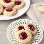 vegan raspberry thumbprint cookies on small lace plate