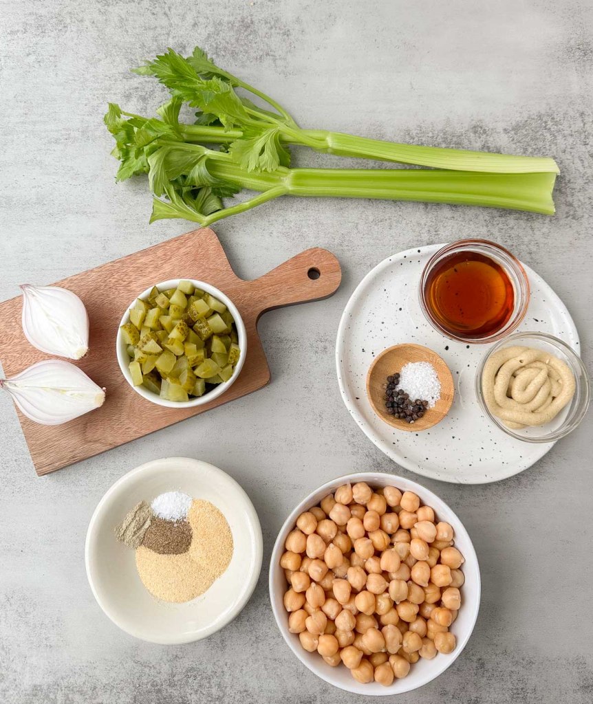 Ingredients to make chickpea salad on a white marble surface