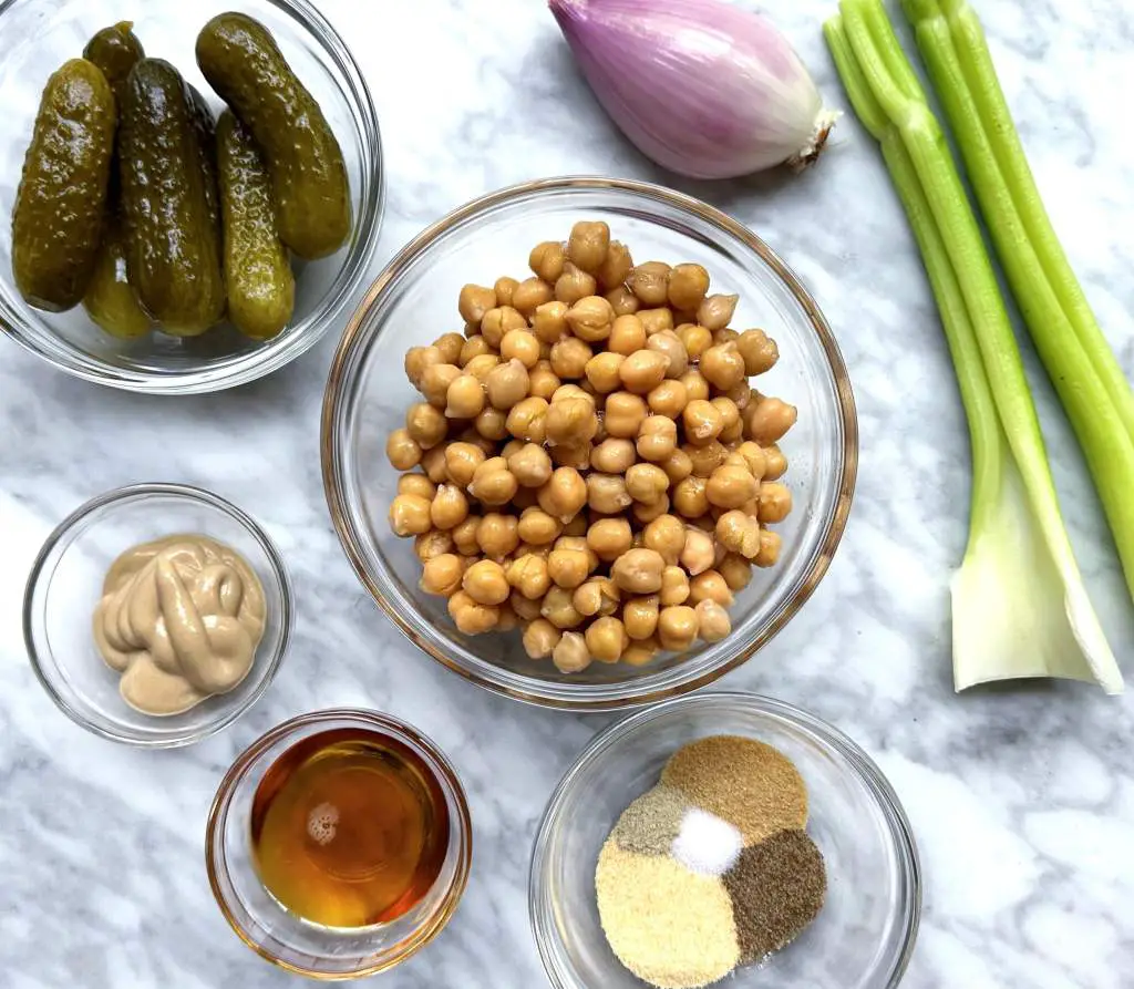 Ingredients to make chickpea salad on a white marble surface