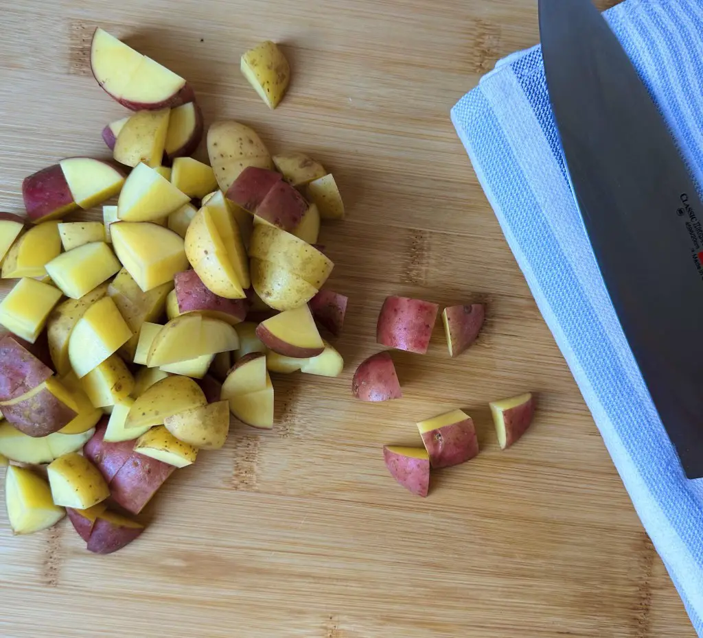 Chopped baby potatoes with chefs knife 