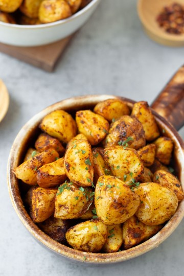 Finished vegan breakfast potatoes in small brown crock