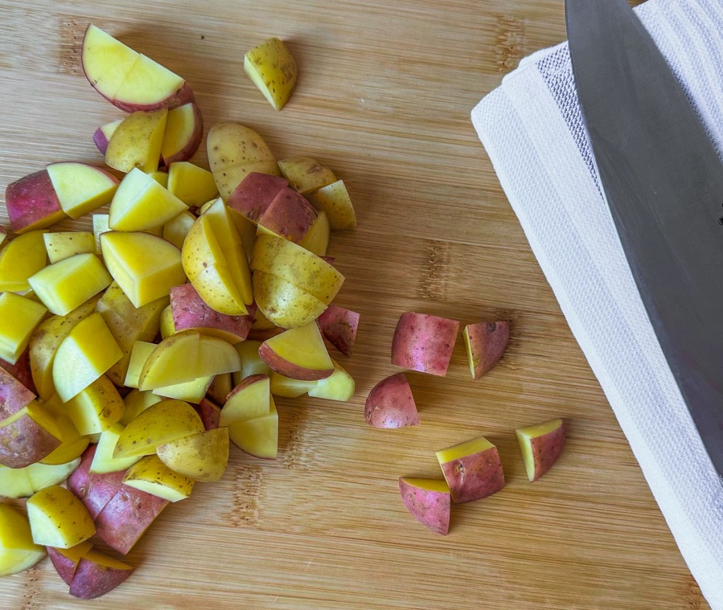 Chopped baby potatoes with chefs knife