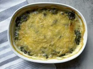 FInished vegan spinach artichoke dip in baking dish.