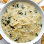 top view of a white bowl with vegan spinach artichoke dip