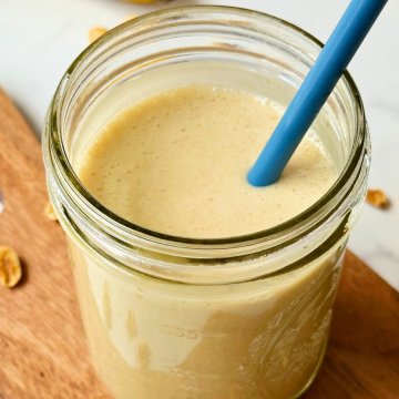 finished vegan banana oat smoothie in a glass mason jar