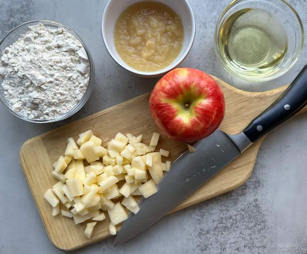 diced apple on a cutting board with remaining ingredients