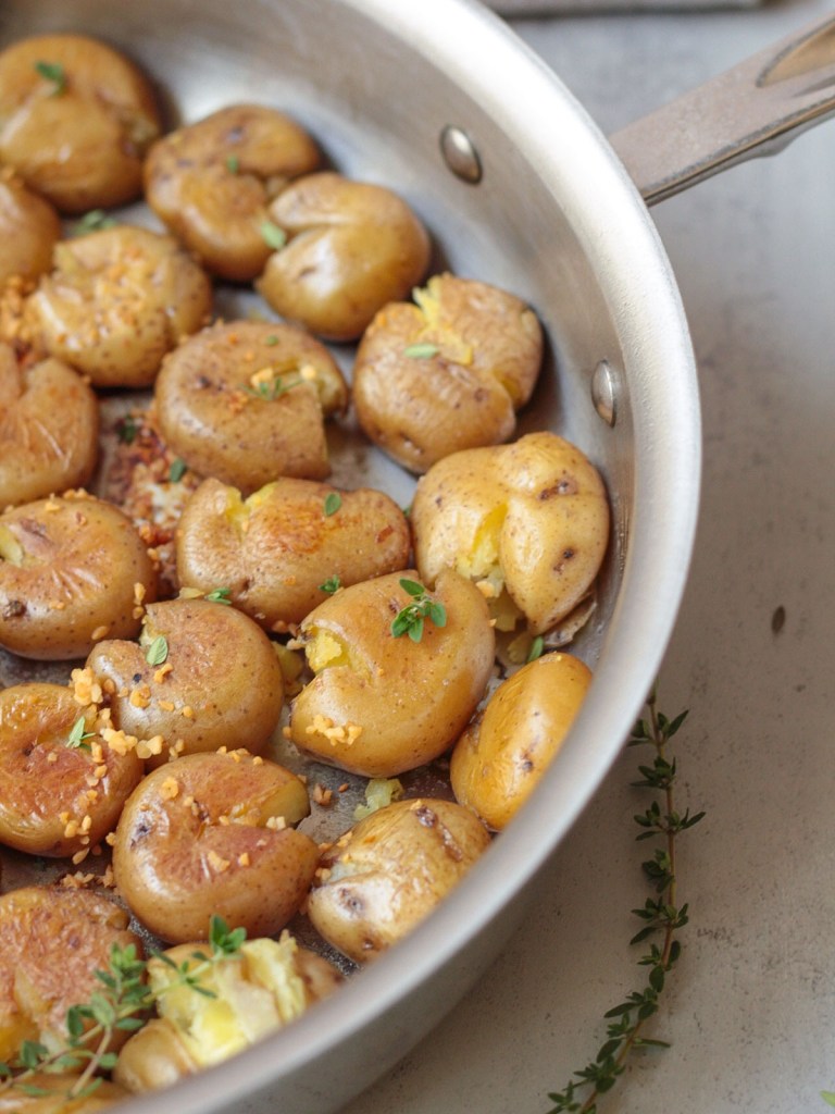 finished crispy garlic smashed new potatoes in pan