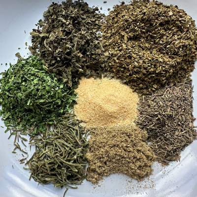 italian herbs in bowl before mixing