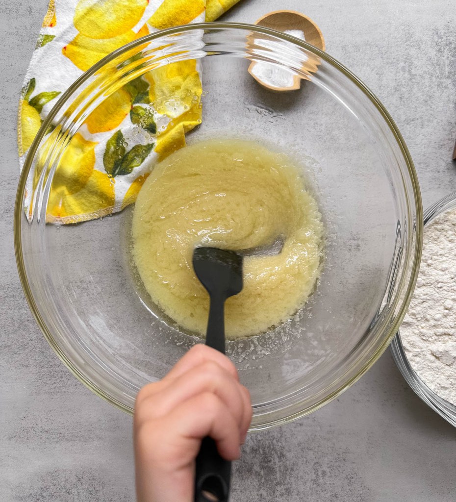 oil and sugar mixed in a mixing bowl for lemon cookies