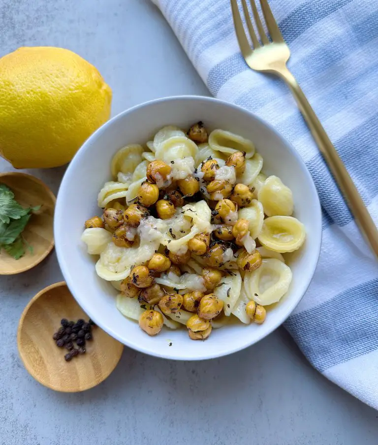 A finished bowl of roasted chickpea lemon pasta on a grey background