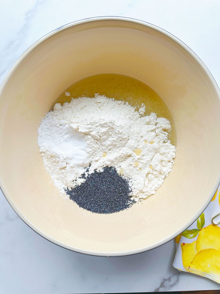 All ingredients for vegan lemon poppy seed bread in a mixing bowl, prior to being mixed