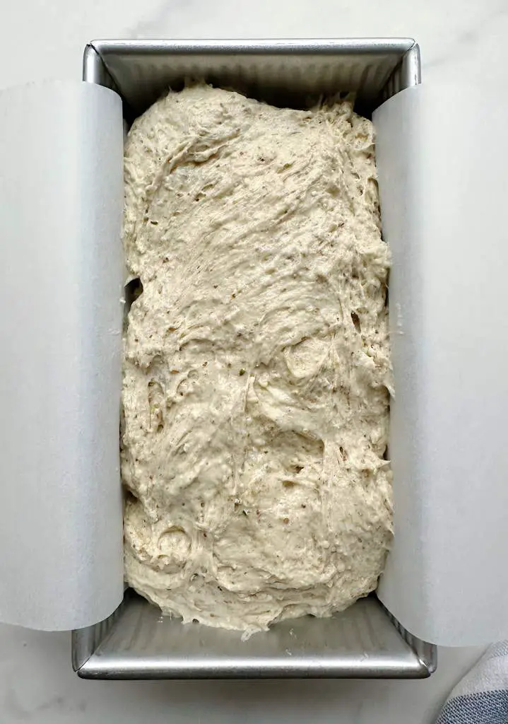 dough in parchment-lined loaf pan