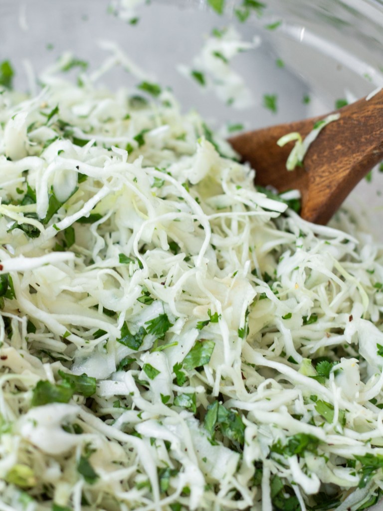 mixed cilantro lime cabbage slaw in a glass bowl