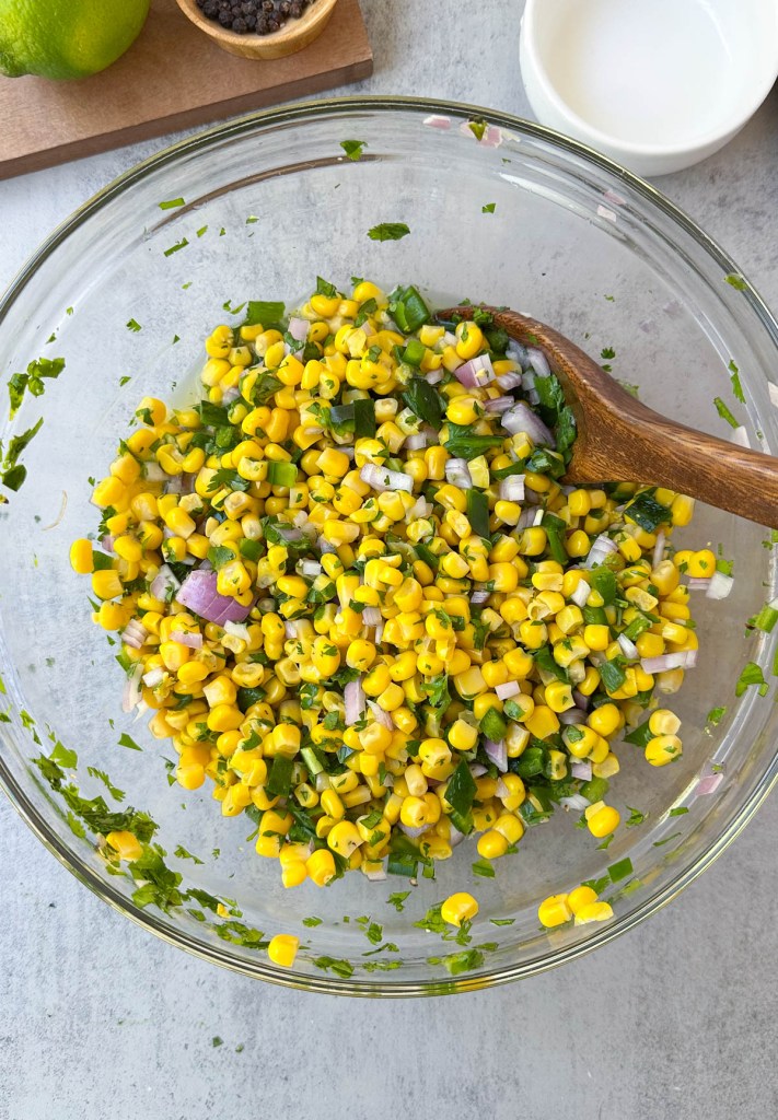 corn salsa mixed in mixing bowl