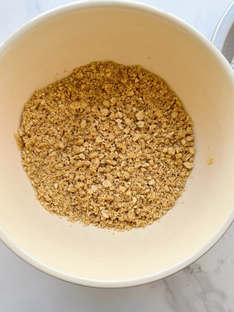 ingredients for easy vegan graham cracker pie crust recipe in a mixing bowl