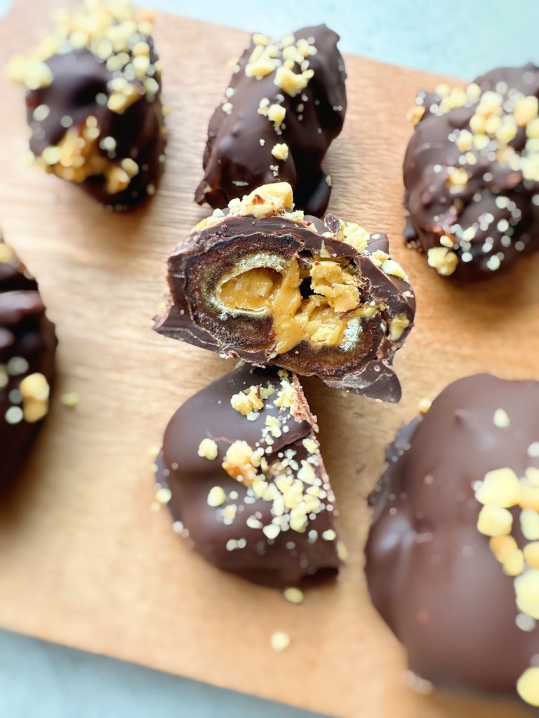 Finished crunchy peanut butter stuffed dates sliced to show inside