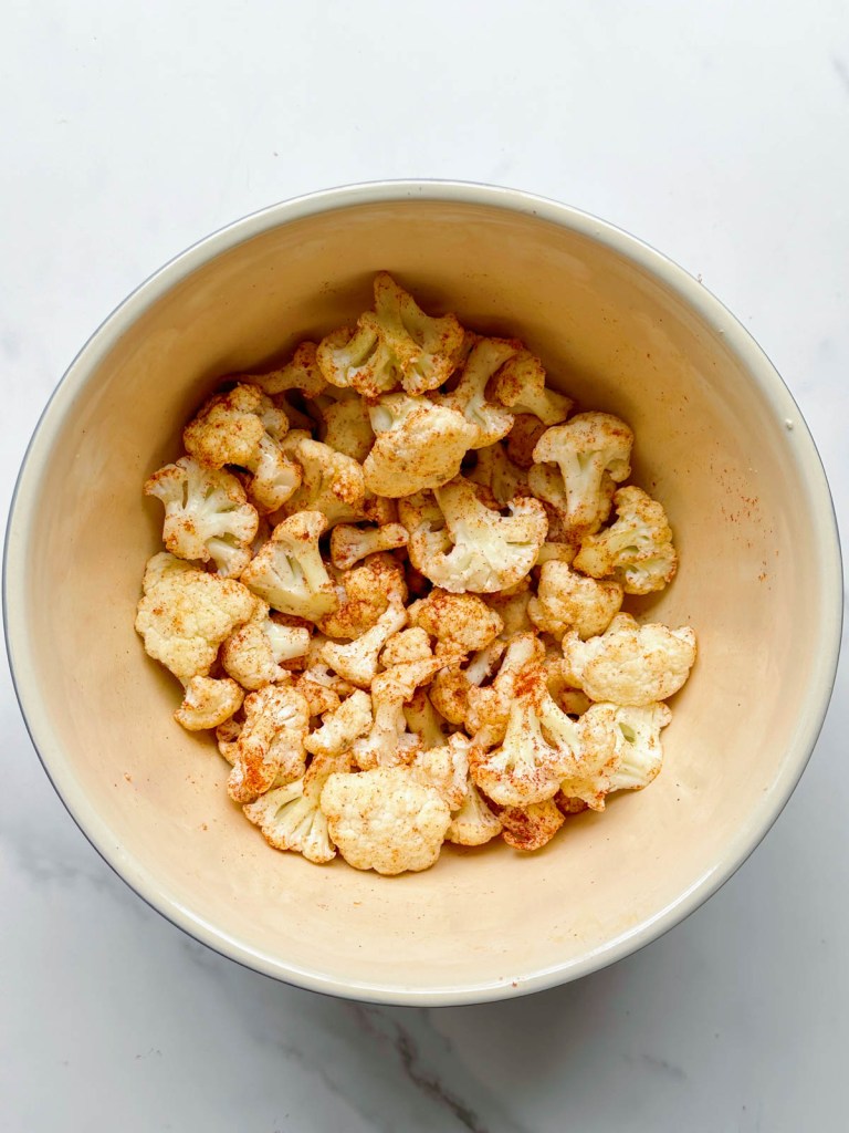 uncooked cauliflower coated in spices