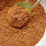 shawarma spices being mixed with measuring spoon in bowl