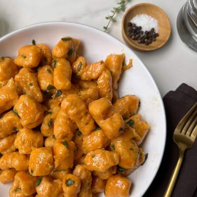 finished vegan sweet potato gnocchi in a white bowl