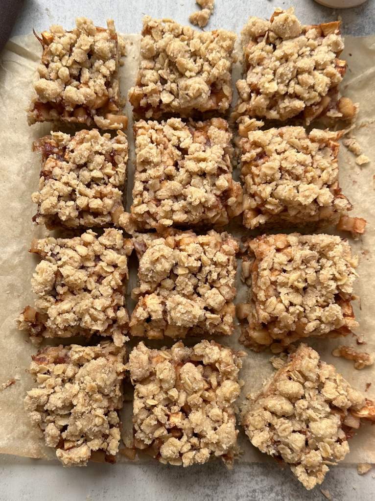 vegan apple pie crumble bars sliced on parchment paper
