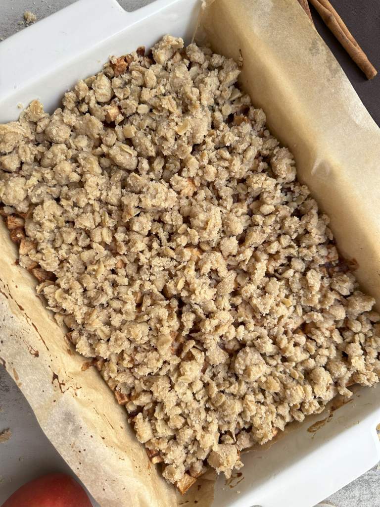 finished vegan apple pie crumble bars in baking dish