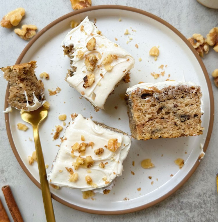 finished slices of vegan banana walnut cake with vegan frosting and crushed walnut topping