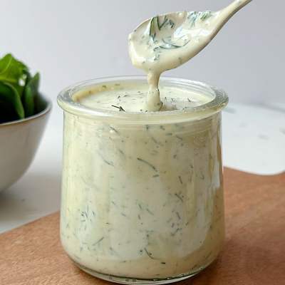 finished vegan dill tahini dressing with spoon taking scoop out