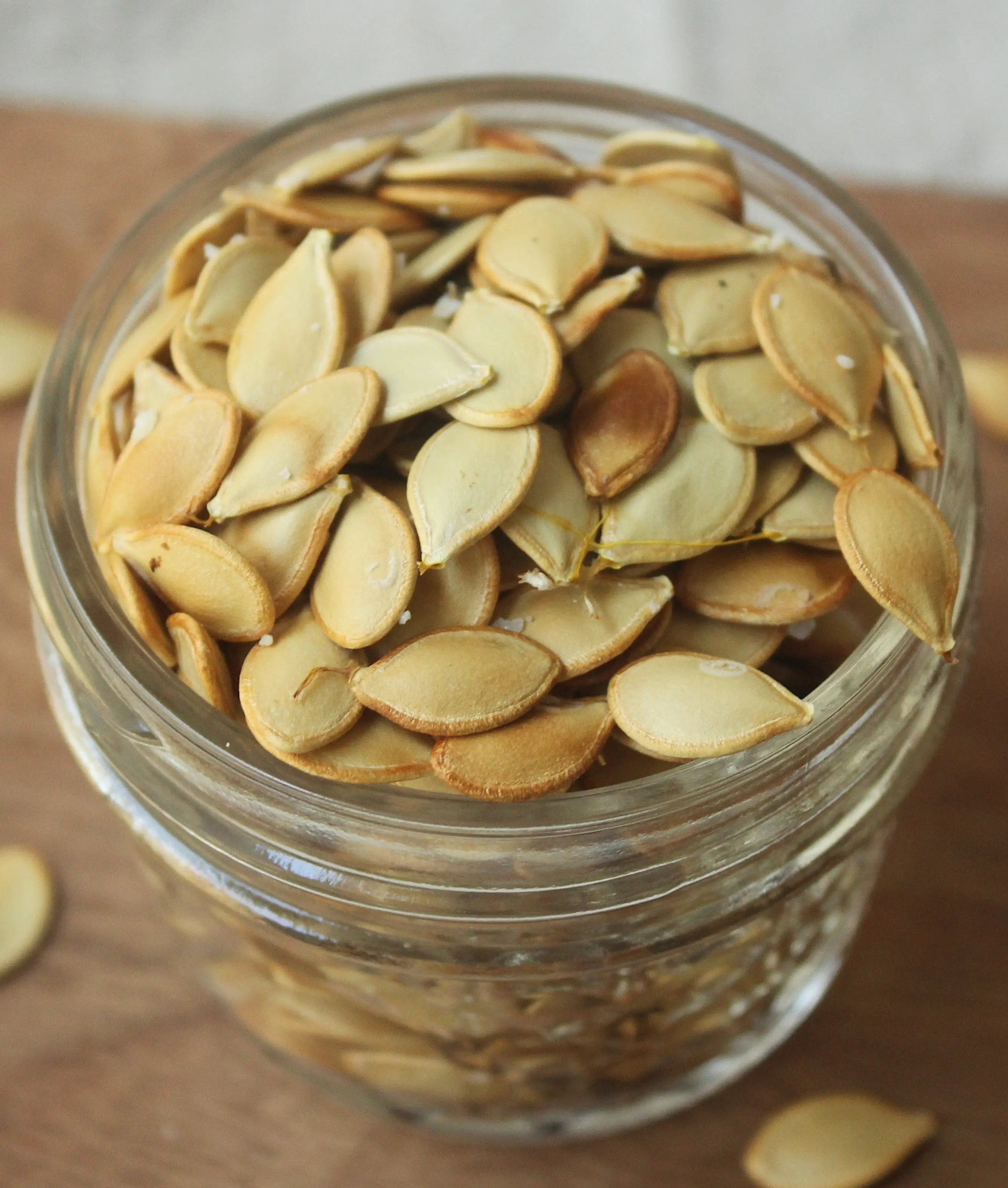 finished roasted acorn squash seeds in glass container